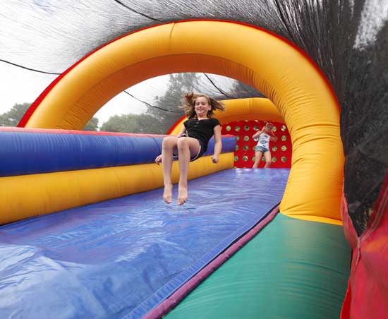 Sofia MacLean bounces down an inflatable slide. 