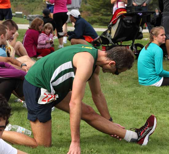 A runner stretches before the start of the 10K Apple Harvest Ramble on Oct. 3.