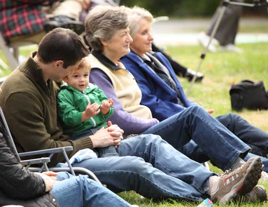 Jim’s son Ben, grandson Jack, wife Lucy, and Kathy Jackson listen to the band’s rendition of “Trumpeter’s Holiday.”