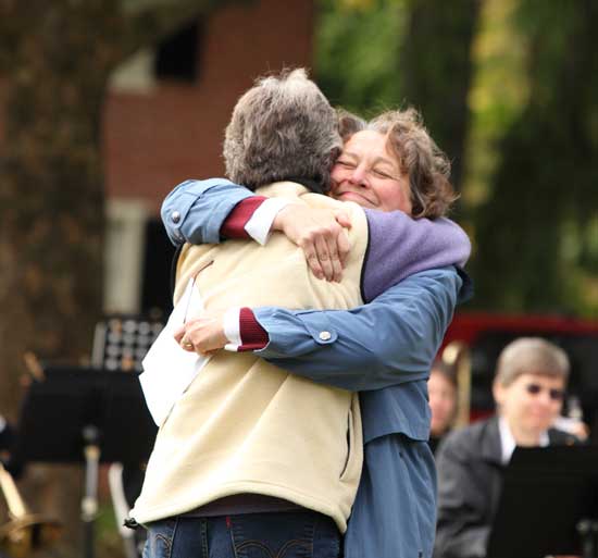 Lucy Wallace embraces Debbie Kaegebein after Kaegebein spoke about Jim’s years of singing with the Congregational Church choir.