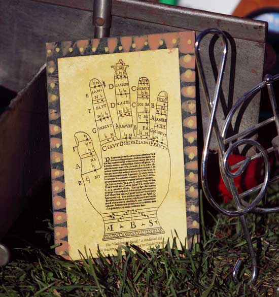 A palm-reading chart and a G-clef coat rack are for sale. 