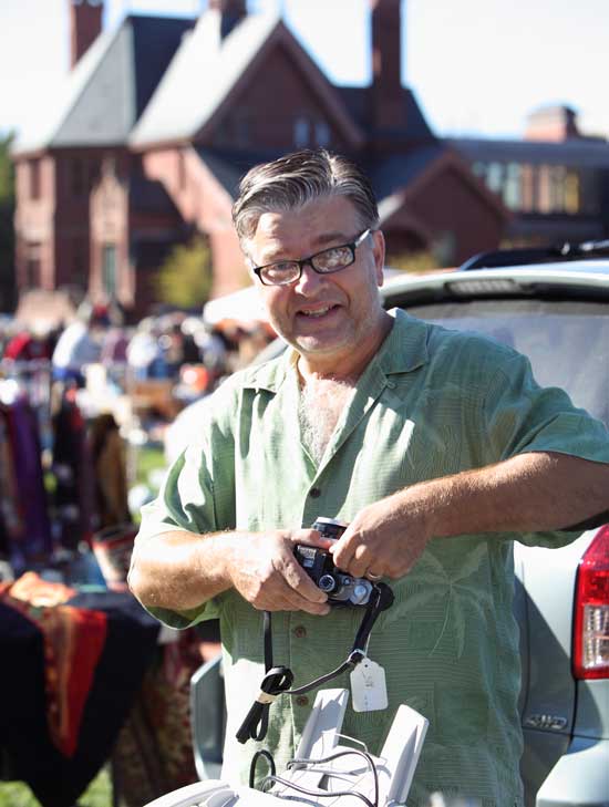 Bob Hubert shows a Nikon camera to a customer at his booth. 