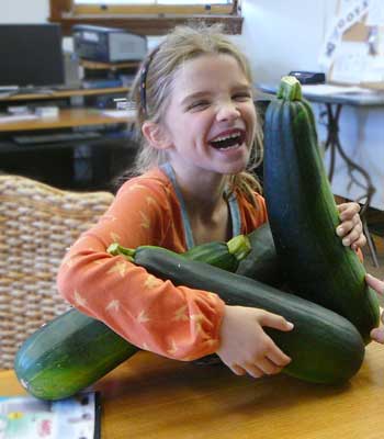 Julia Clark with her mega zucchinis.(Photo by Worth Robbins) Julia Clark with her mega zucchinis.(Photo by Worth Robbins)
