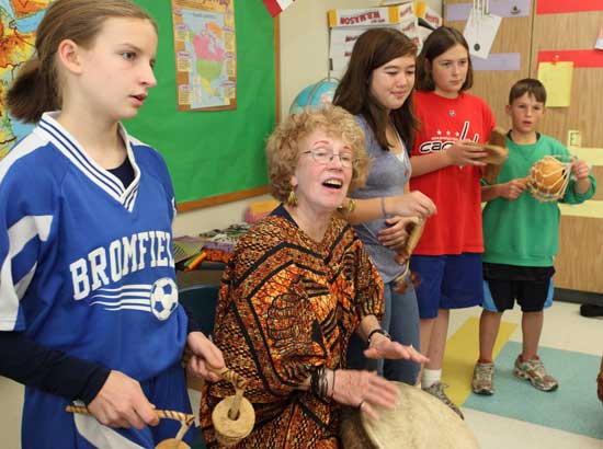 From left, Gwyneth Burns, Judy Lorimer (former Harvard teacher and representative from the nonprofit Build a School in Africa), Amy Hunter, Bolek Myczkowski, and Nathan Dutkewych sing and play percussion instruments during a seventh grade geography class.