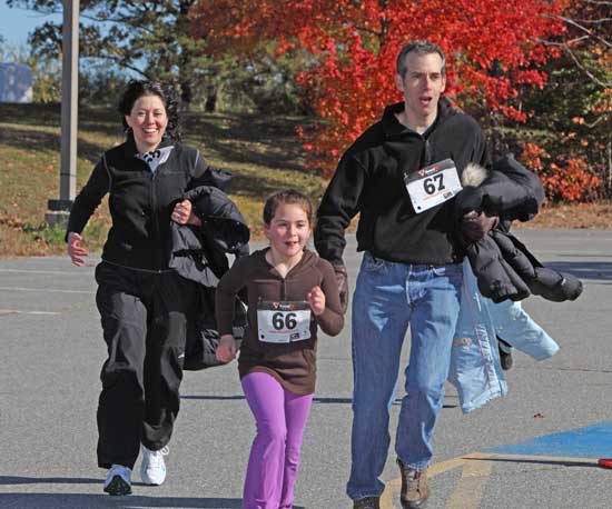 Maria, Mia, and Bruce Maisel approach the finish line of the Celebrate Childhood Fun Run with smiles on their faces on Oct. 23.