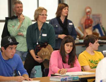 From left, Bromfield students Zak Shields, Elizabeth Swain, and Conor Tingle take notes in an anatomy class as teachers from Iceland observe from the back of the room. (Photo by Lisa Acuikewicz)