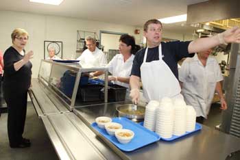 From left, Gutnin Sigunardoth asks what’s for lunch as Paul Correnty, Cindy Prescott, and Icelander Chef Hans Helgi Stefansson serve lunch at the Bromfield School. (Photo by Lisa Aciukewicz)