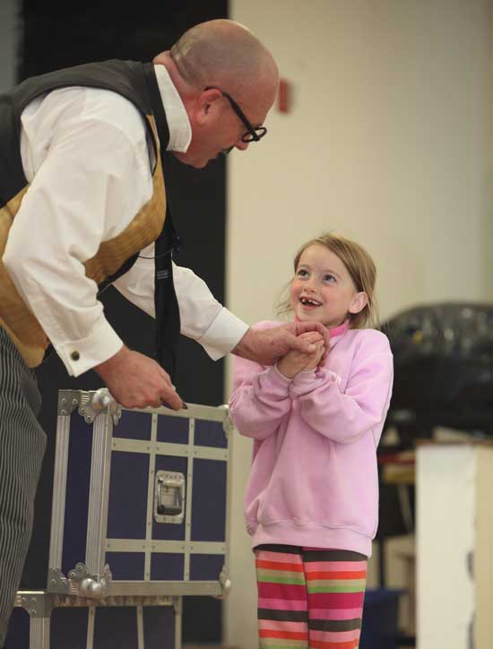 Sophie Thompson willingly volunteers to perform with  the The Stupendous Mr. Magichead at a Village Nursery School-sponsored magic show at the elementary school on Oct. 23.