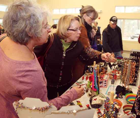 From left, Shirley Boudreau and Mary Jo Boynton peruse the merchandise at the Fair Traide Fair held at the Unitarian Church Fellowship Building on Nov. 7.