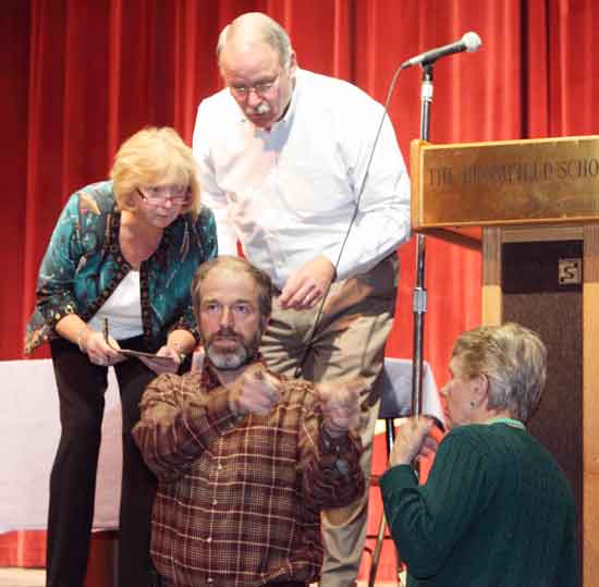 From left, Town Clerk Janet Vellante, counter Jim Ware, Moderator Bob Eubank, and counter Pat Jennings confer on the number of yes and no votes on Article 5 during the Special Town Meeting in Cronin Auditorium on Nov. 9.