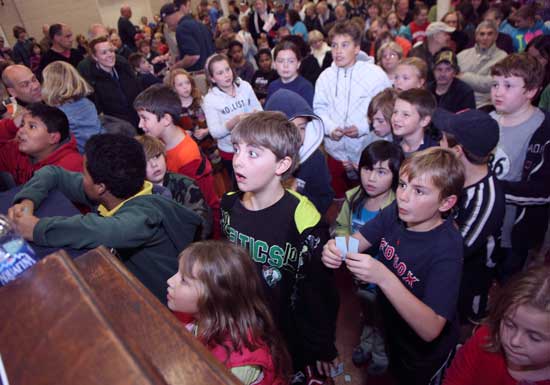The anticipation is palpable as the winning tickets for a “kids round” are called at the turkey raffle..