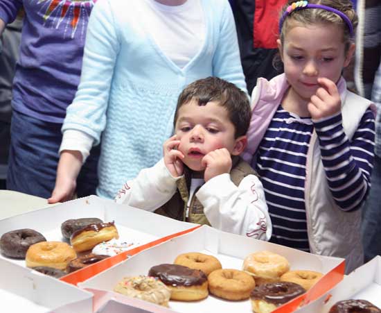 Decisions, decisions! Stavros and Stelliann Bassi take their turn deciding which donought to devour.