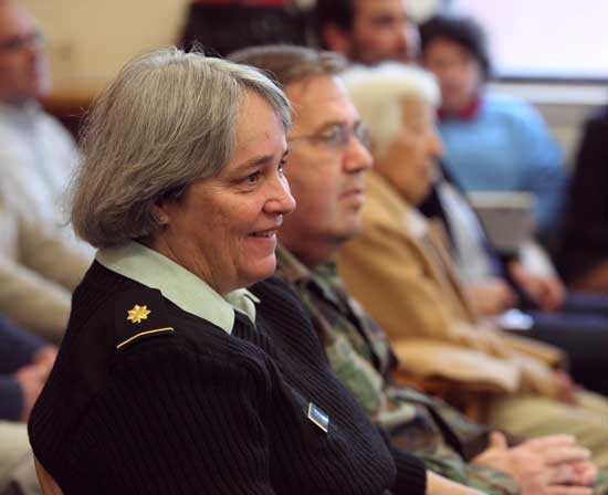 Nancy Cronin listens to Dennis Lyddy, Harvard’s Veterans’ Services Agent.