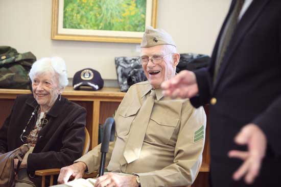 Lois and Bill Doe listen as Bob Eubank speaks at a Veterans Day ceremony in the old library on Nov. 11. Doe was presented medals honoring his contributions during World War II.  