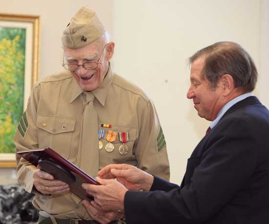 Selectman Ron Ricci presents a plaque to Doe