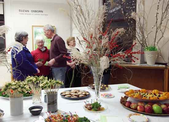 Sue Colwell, Joanne Williamson, and Dick Clawson share a conversation at an open house in the old public library on Nov. 20.