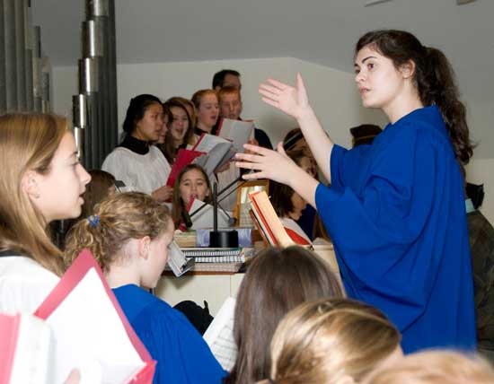 Bromfield senior Molly O’Rourke-Friel conducts the choir as part of her senior community service project. (Photo by Kathryn Costello)