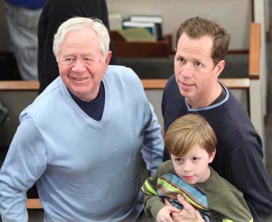 From left Don, Kian, and David Oldham look for Kian’s sister, Shea, in the choir loft.