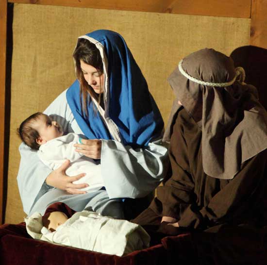 Julia D’Anello, as the baby Jesus, gazes at Lexie Dutkewych as Alex Cadman looks on.