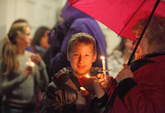 Colin Murphy and his grandmother Pam Murphy hold candles as the pageantgoers head to the Christmas Tree lighting.