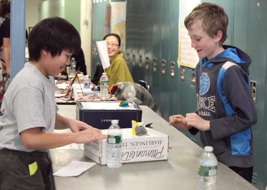 Ross Hayao (left) and Paul Chapman engage in a game of paper sumo wrestling.
