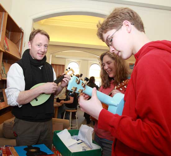 Danno Sullivan (left) shows Andrea Hill a ukelele as her son Alex takes one for a test drive