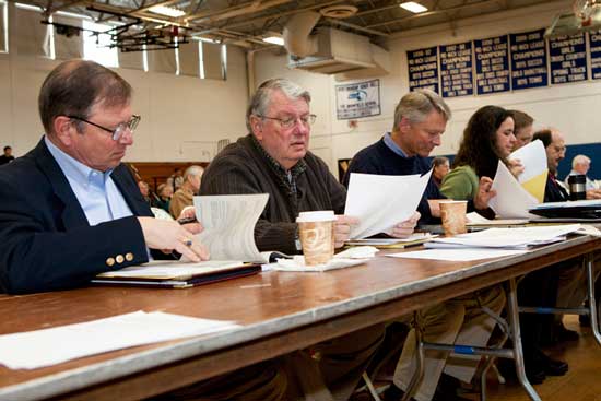 The Board of Selectmen studies the warrant articles.