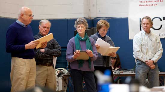 The Municipal Buildings Committee waits near the front of the gym as Selectman Peter Warren presents an amended Article 17.