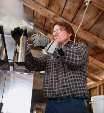 Jim Burns uses a hydrometer to measure the sugar content in his maple syrup. (Photo by Lisa Aciukewicz)