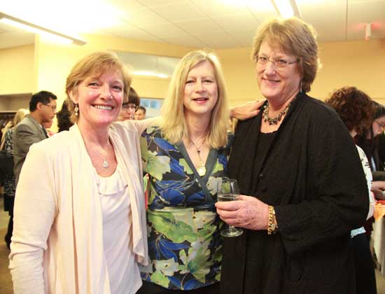 From left, Beth Walker, Karen Shea, and Sally Steele pose for a photo and a glass of wine before dinner.