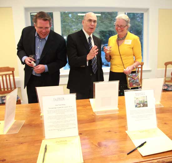 From left, Charles Redinger, Kent Boynton, and Molly Cutler get their bids in during the silent auction.