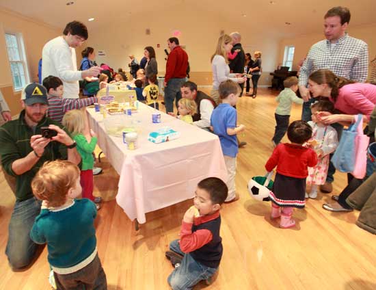 Undaunted by the rainy day, families enjoy cookies and crafts at the Harvard Family Association spring egg hunt in the Congregational Church hall.