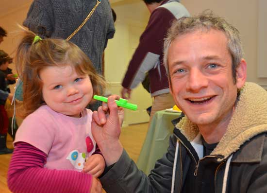 Noemi and Colin Loggins finish an impromtu kazoo lesson at the Harvard Family Association egg hunt. (Photo by John Sharko).