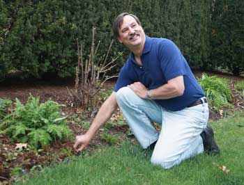 Jon Panek checks out the new growth in his garden. (Photo by Lisa Aciukewicz) Jon Panek checks out the new growth in his garden. (Photo by Lisa Aciukewicz)