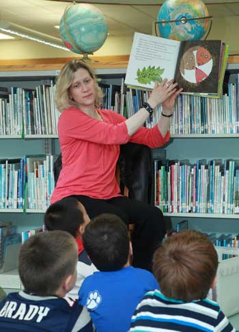 Abby Kingsbury reads to a group of youngsters at the public library. (Photo by Lisa Aciukewicz)