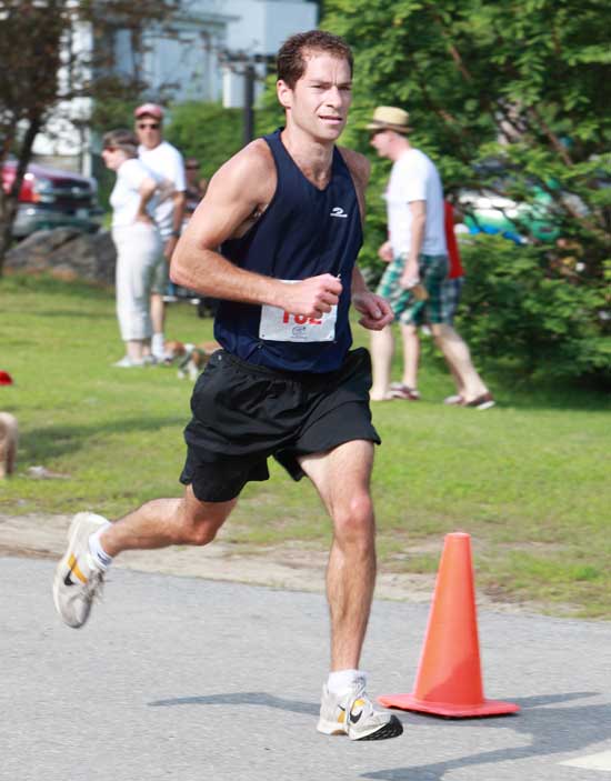 Nick Parker is the first Harvard resident to cross the finish line in the Great Harvard Fourth of July 5-Mile Race.  (Photo by Lisa Aciukewicz)