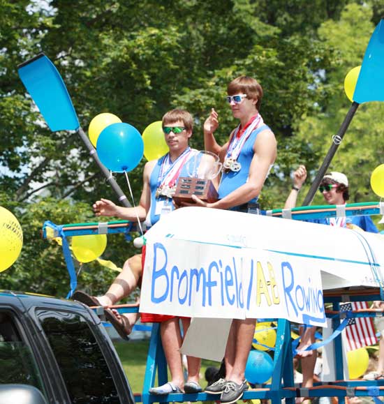 Rowing champs Kendall Cotton and Sam Ginouves wave to the crowd. (Photo by Lisa Aciukewicz)