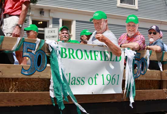 Members of Bromfield's class of 1961, celebrating their 50th reunion over the Fourth of July weekend, take in the view from their float.  (Photo by Lisa Aciukewicz)