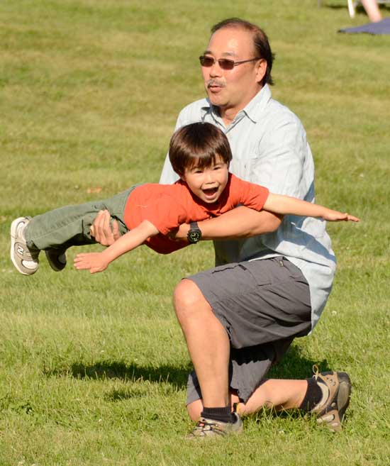Christopher Kanki takes flight with the help of his father, John Kanki. (Photo by John Sharko)
