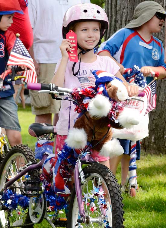 Kendall Richmond shows off the ribbon she won for her decorated bike. (Photo by John Sharko)