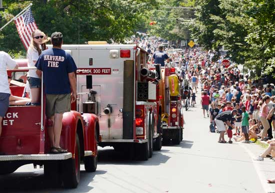 Firetrucks bring up the rear of the parade as residents crowd the streets. (Photo by Katy Sharko)