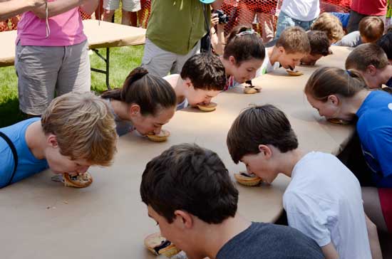 Participants in the pie-eating contest show their technique. (Photo by John Sharko)