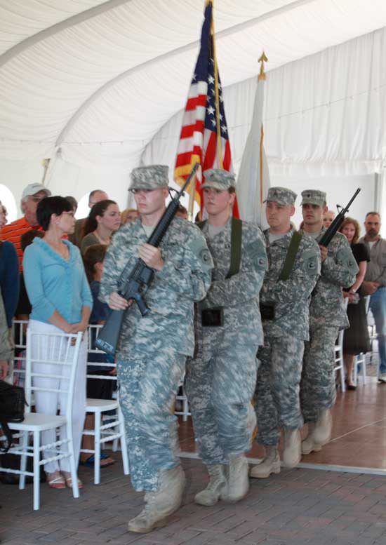 Soldiers enter with the flag to commence the remembrance ceremony at Fruitlands Museum. 