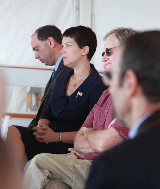 State Senator Jamie Eldridge (far left) and Representative Jen Benson watch the ceremony at Fruitlands.