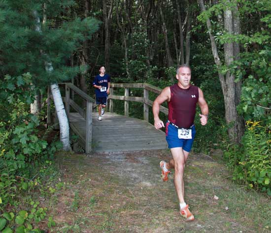  Bruce Folsom of Ashby runs through the woods near McCurdy Track.
