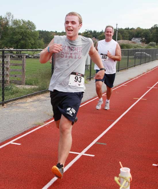 A happy Justin Miller nears the finish line ahead of Michael Murphy.