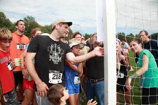 Runners gather to check out their times and see how they placed in the Run for the Hills race. 