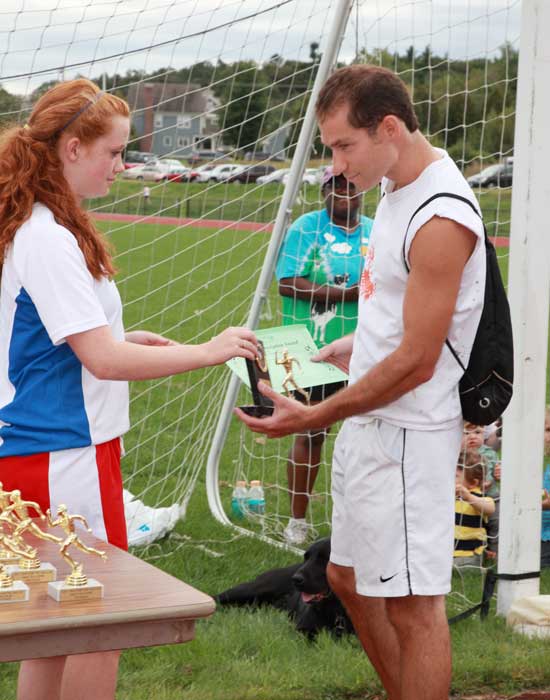 Nick Parker picks us his prize from Evelyn MacMahon after winning the 5K race with a time of 17:08.