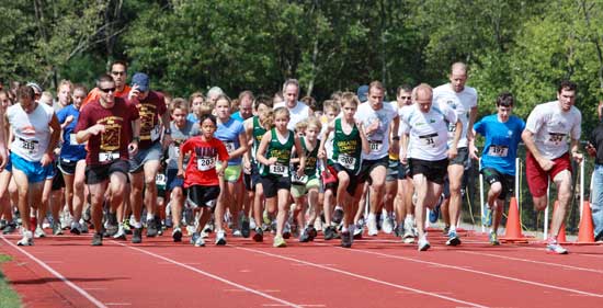 Runners pick up speed at the beginning of the Conservation Trust 5K Run for the Hills, which started at McCurdy Track and continued into the abutting woods. 