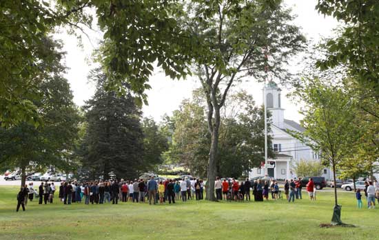 A crowd gathers on the common on Sept. 11 for a service conducted by the Congregational, Catholic, and Unitarian Universalist clergy and the Harvard Fire Department. 